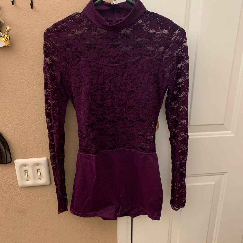 Wow. Knock out bright purple body suit w/shorts